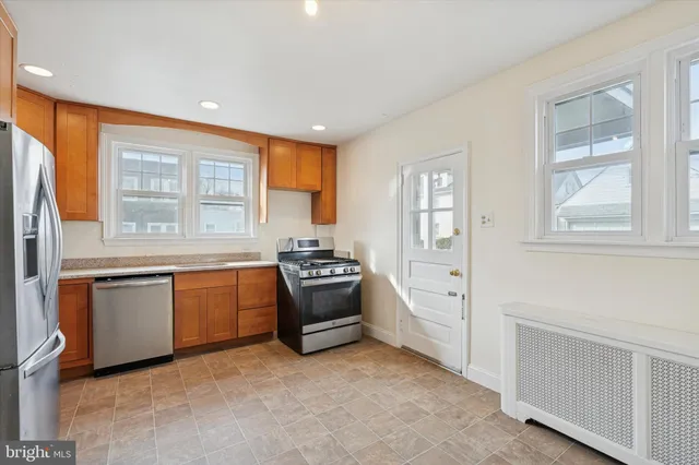 a kitchen with granite countertop a stove top oven sink and cabinets