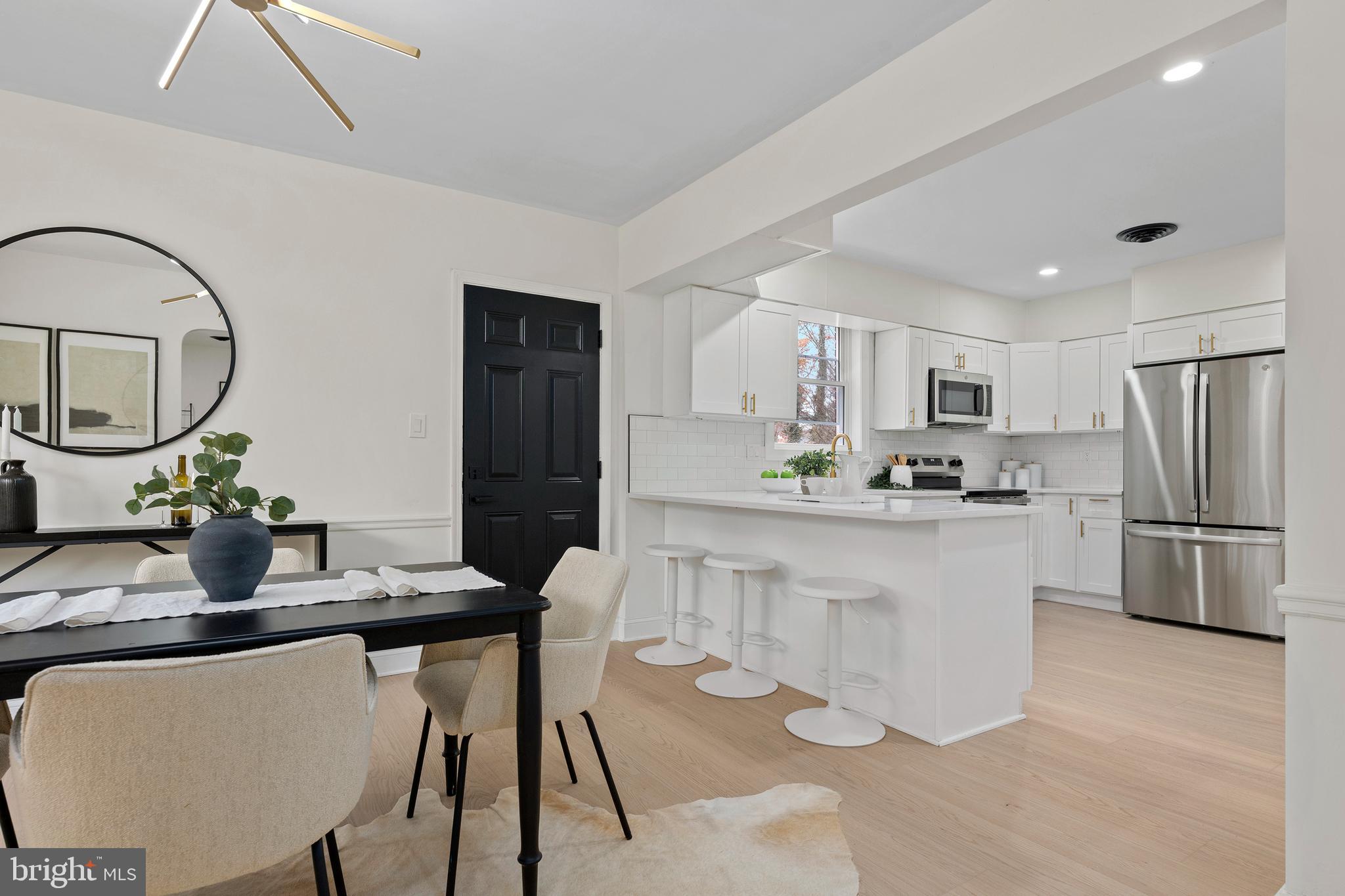 a kitchen with white cabinets and stainless steel appliances