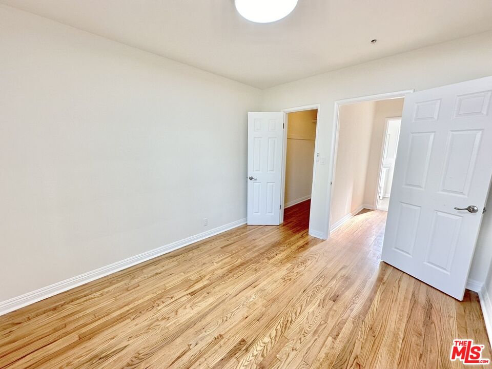 10720 Charnock Road Los Angeles, CA 90034 - Photo 18 of 33 a view of an empty room with wooden floor and closet
