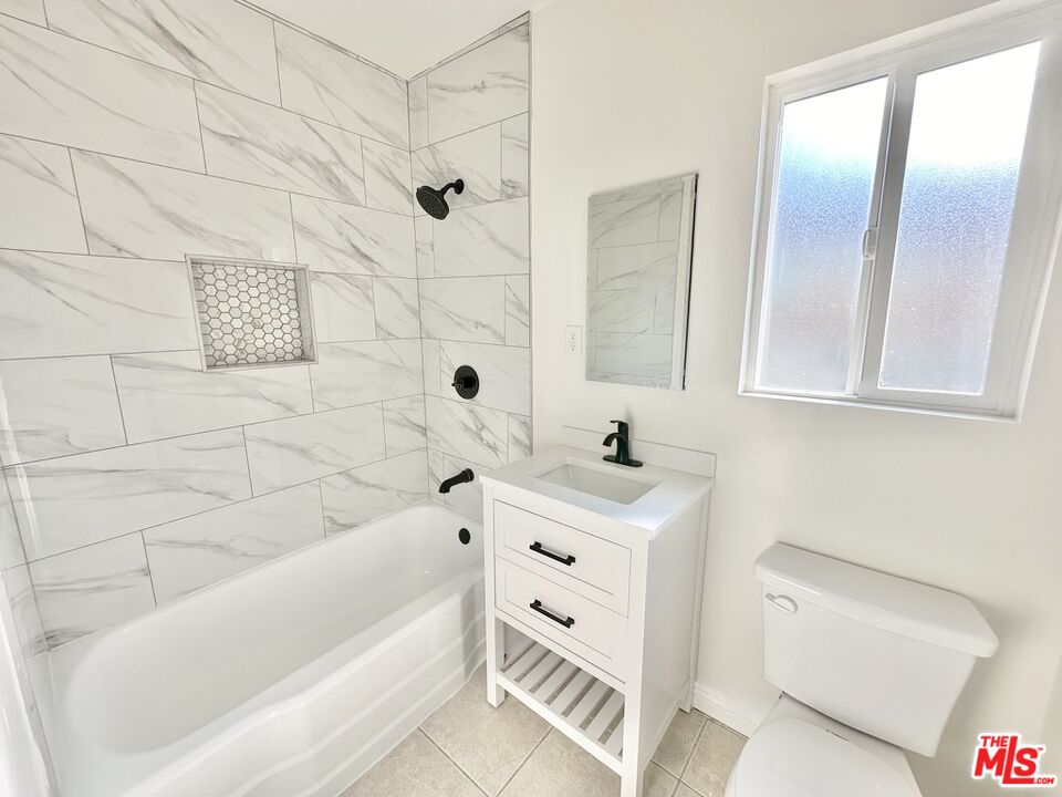 10720 Charnock Road Los Angeles, CA 90034 - Photo 19 of 33 a bathroom with a sink a toilet and shower