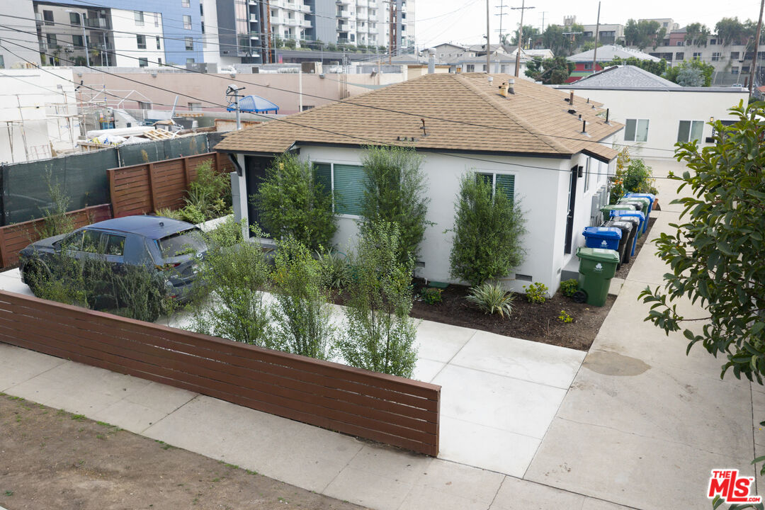 10720 Charnock Road Los Angeles, CA 90034 - Photo 2 of 33 a view of a white house with a yard and potted plants