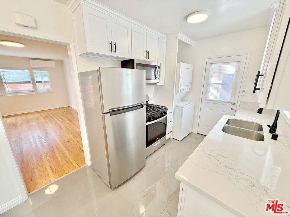 10720 Charnock Road Los Angeles, CA 90034 - Photo 23 of 33 a kitchen with stainless steel appliances a refrigerator sink and microwave