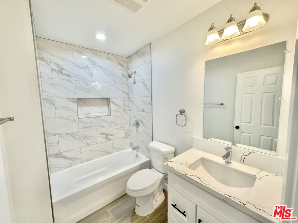 10720 Charnock Road Los Angeles, CA 90034 - Photo 28 of 33 a bathroom with a sink toilet tub vanity and shower