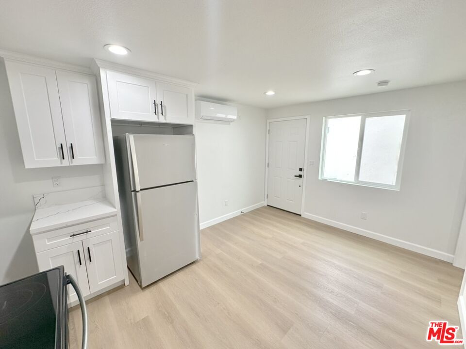 10720 Charnock Road Los Angeles, CA 90034 - Photo 33 of 33 a view of a kitchen with a refrigerator and a stove top oven