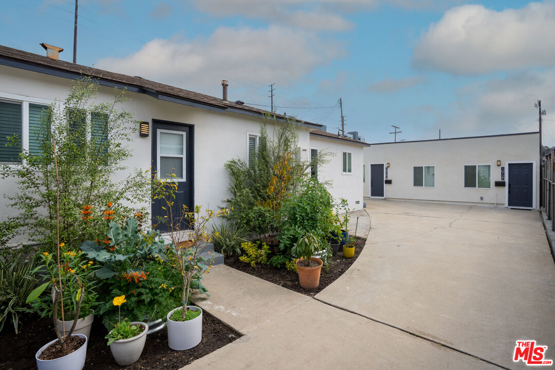 10720 Charnock Road Los Angeles, CA 90034 - Photo 6 of 33 a front view of a house with plants