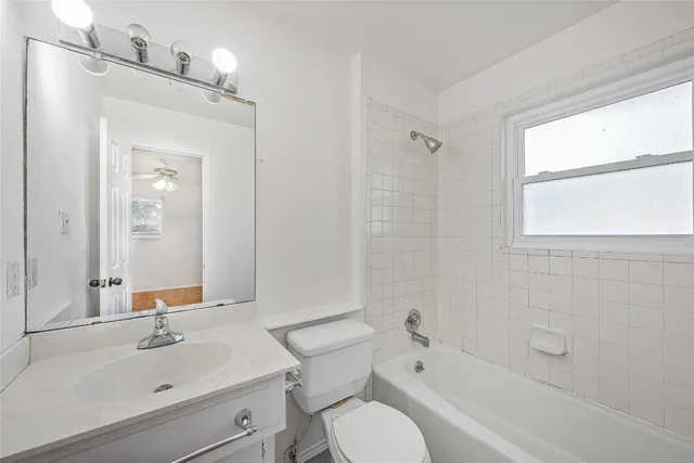 a bathroom with a sink toilet tub and shower