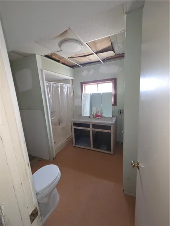 a bathroom with a toilet a sink and a mirror