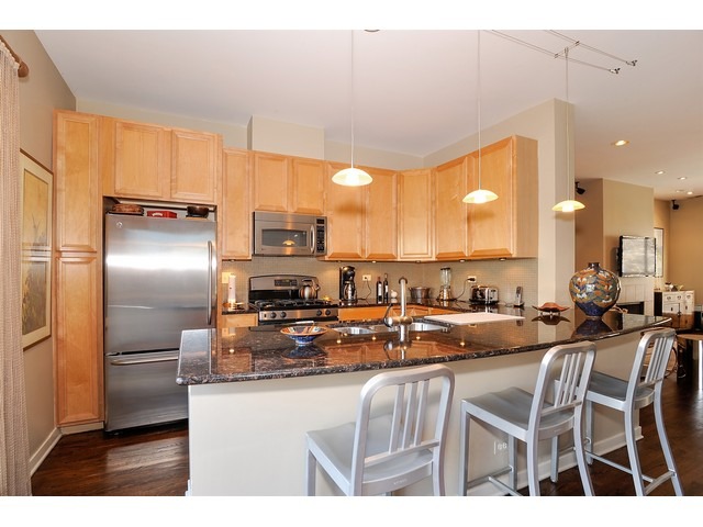 1336 West Fillmore Street Chicago, IL 60607 - Photo 4 of 20 a kitchen with counter top space cabinets and stainless steel appliances