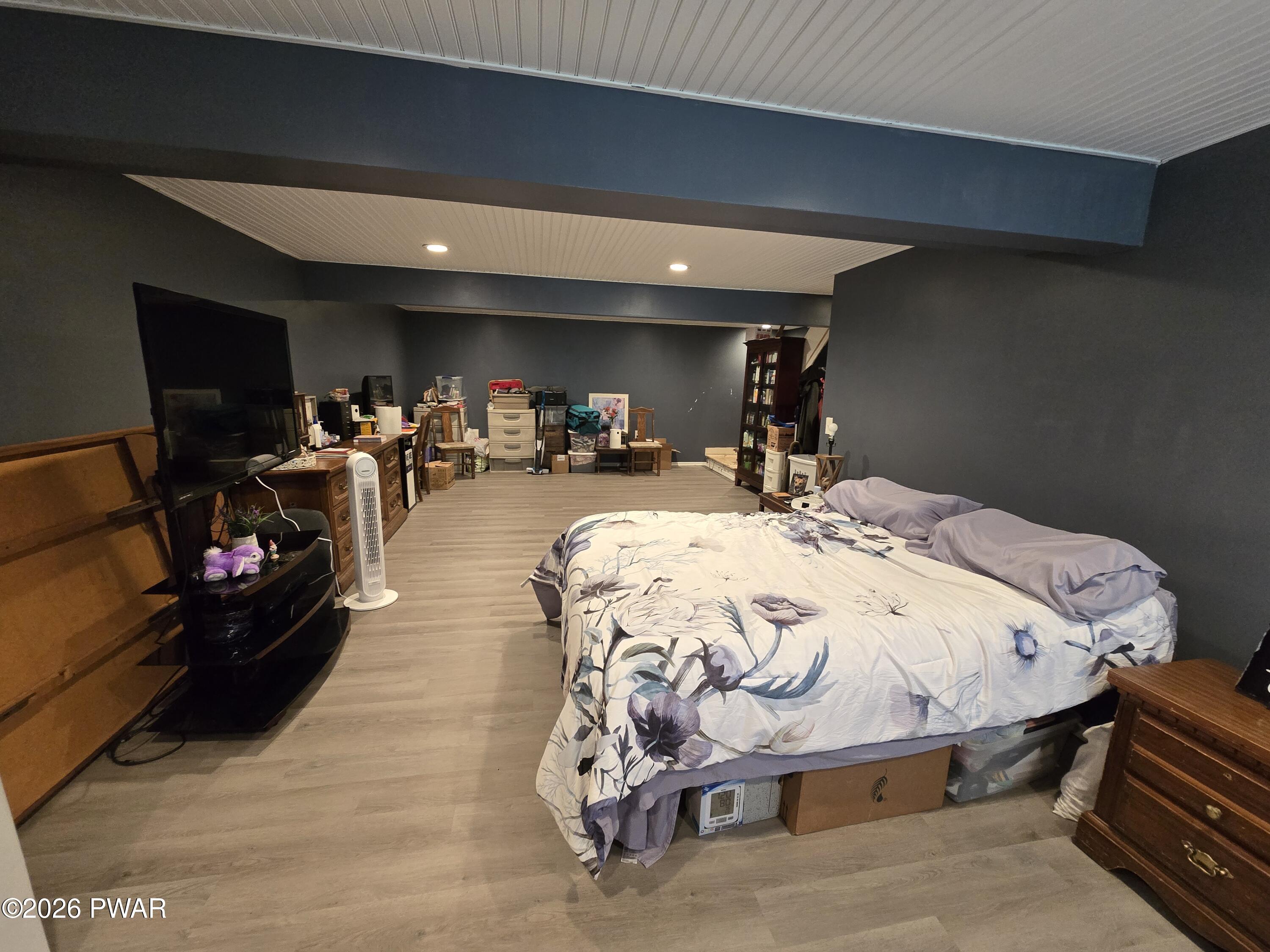 107 Keystone Hls Road, Unit 404 Factoryville, PA 18419 - Photo 5 of 23 a bed sitting in a bedroom and tv