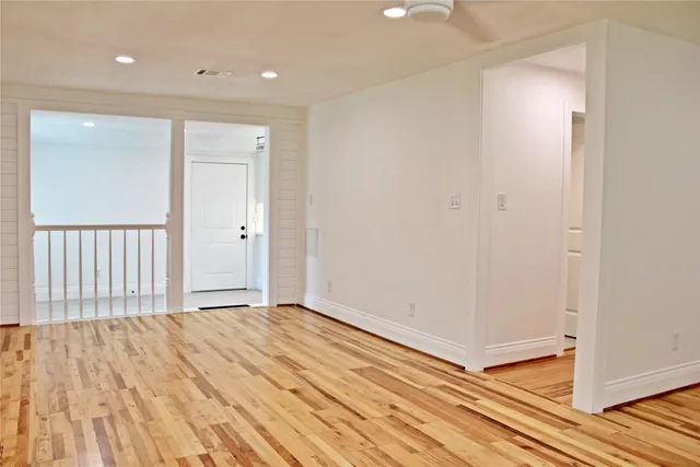 a view of a room with wooden floor