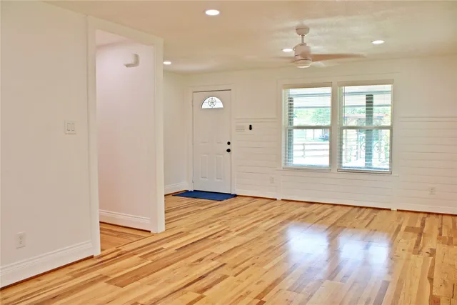 wooden floor in an empty room with a window