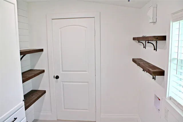 a kitchen with white cabinets and a sink