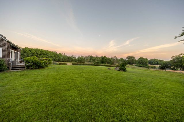 a view of outdoor space with green field and trees