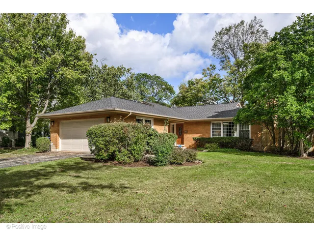 a view of a house with yard and a garden