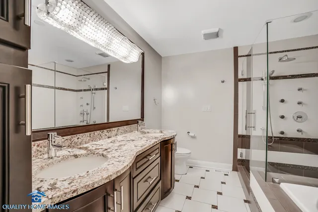 a bathroom with a granite countertop sink a mirror and shower