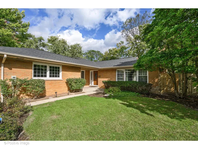 a front view of house with a garden and patio