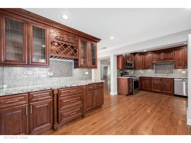 a kitchen with stainless steel appliances granite countertop a sink and cabinets