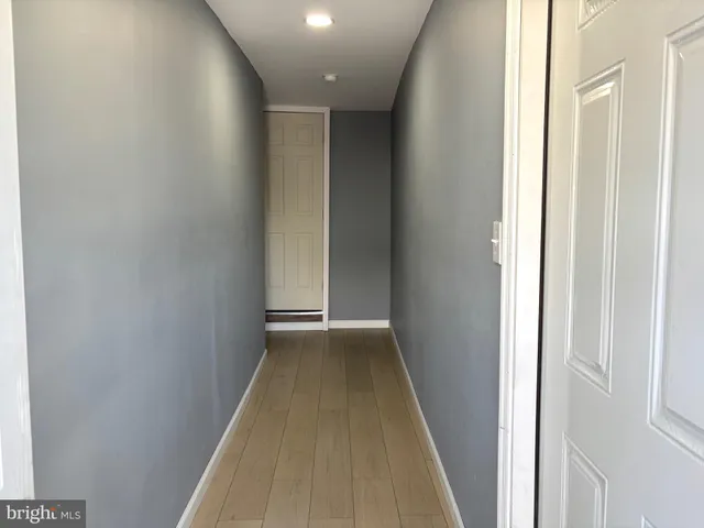 a view of hallway with wooden floor