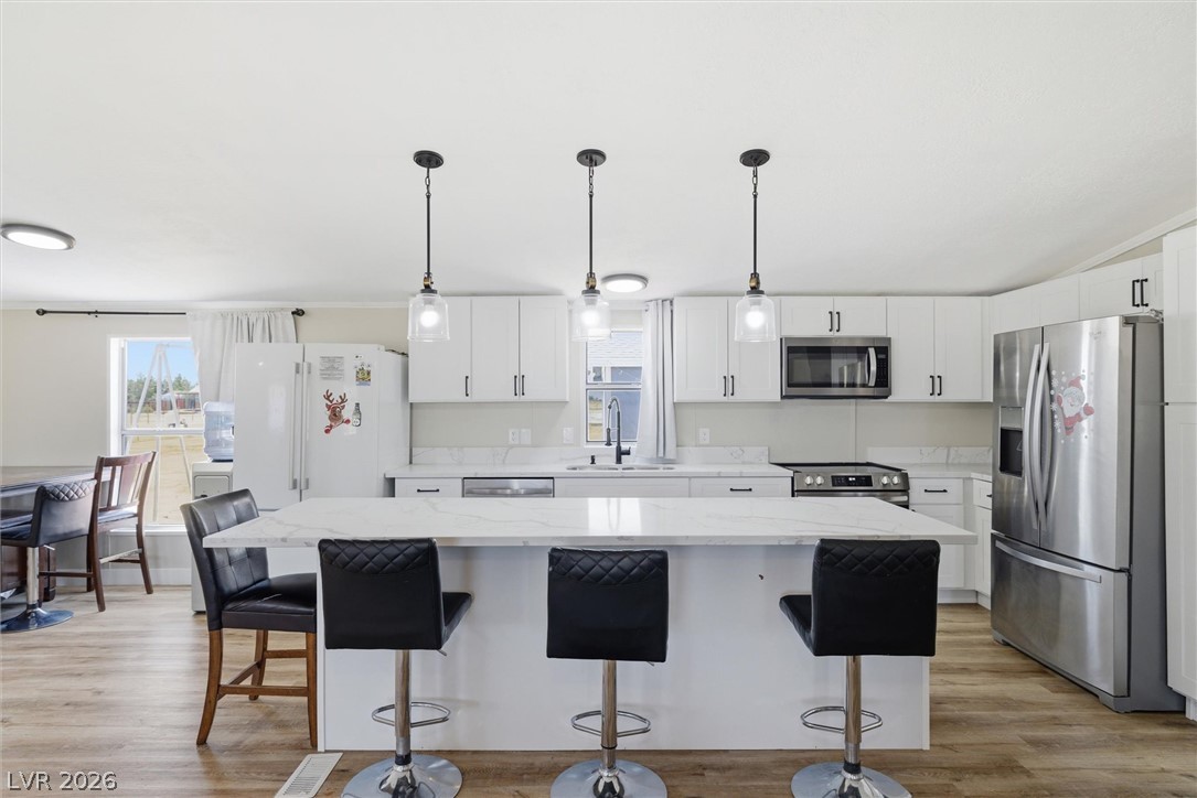 4331 Retread Road Pahrump, NV 89048 - Photo 4 of 31 A well-appointed kitchen features a spacious island with bar seating and modern pendant lighting.
