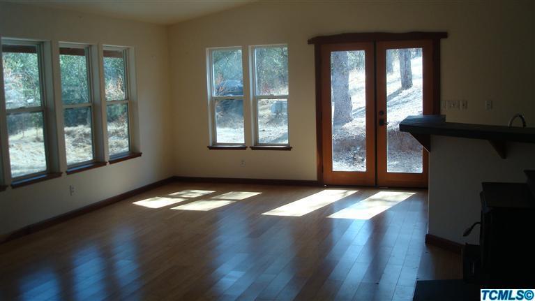 41170 Oak Ridge Drive Three Rivers, CA 93271 - Photo 4 of 9 a view of an empty room with wooden floor and a window