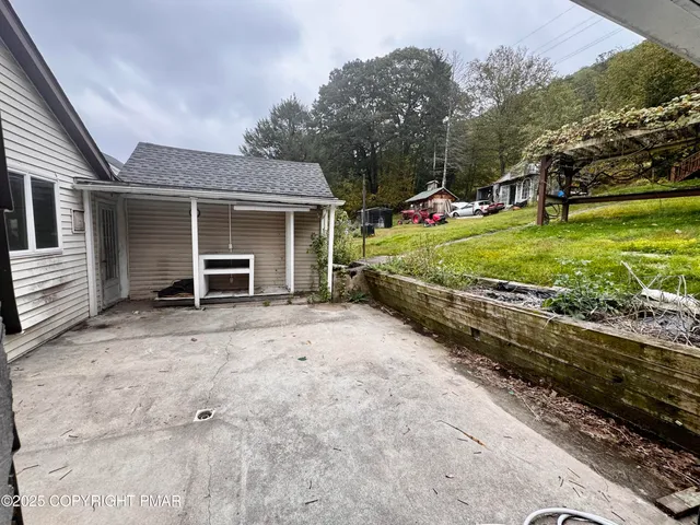 a view of a house with a yard and pathway