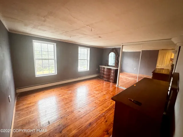 a view of room with window and wooden floor
