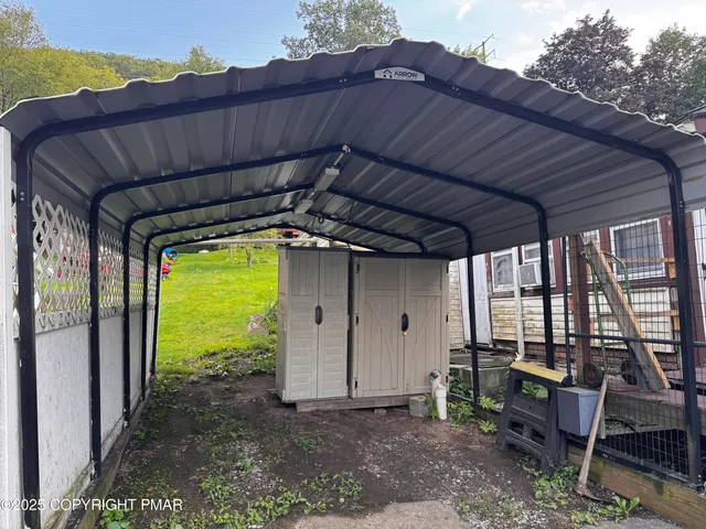a backyard of a house with table and chairs