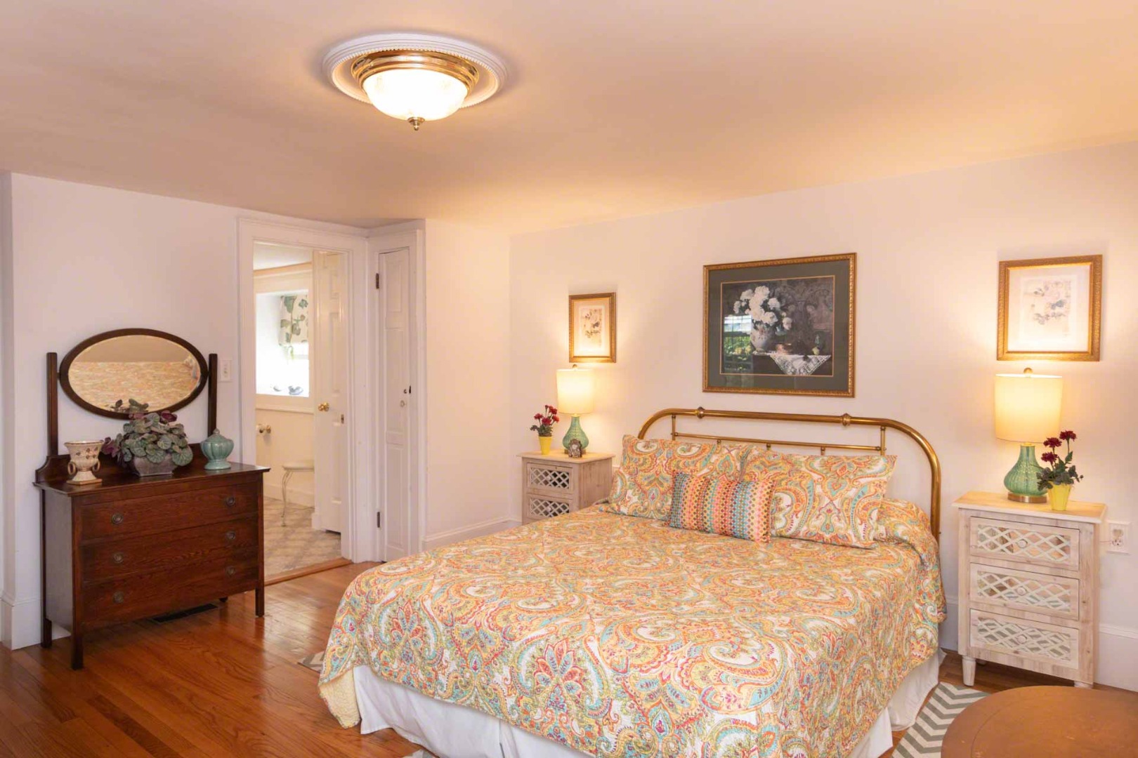 25 High Street Edgartown, MA 02539 - Photo 18 of 26 a bedroom with a bed and a dresser next to a window