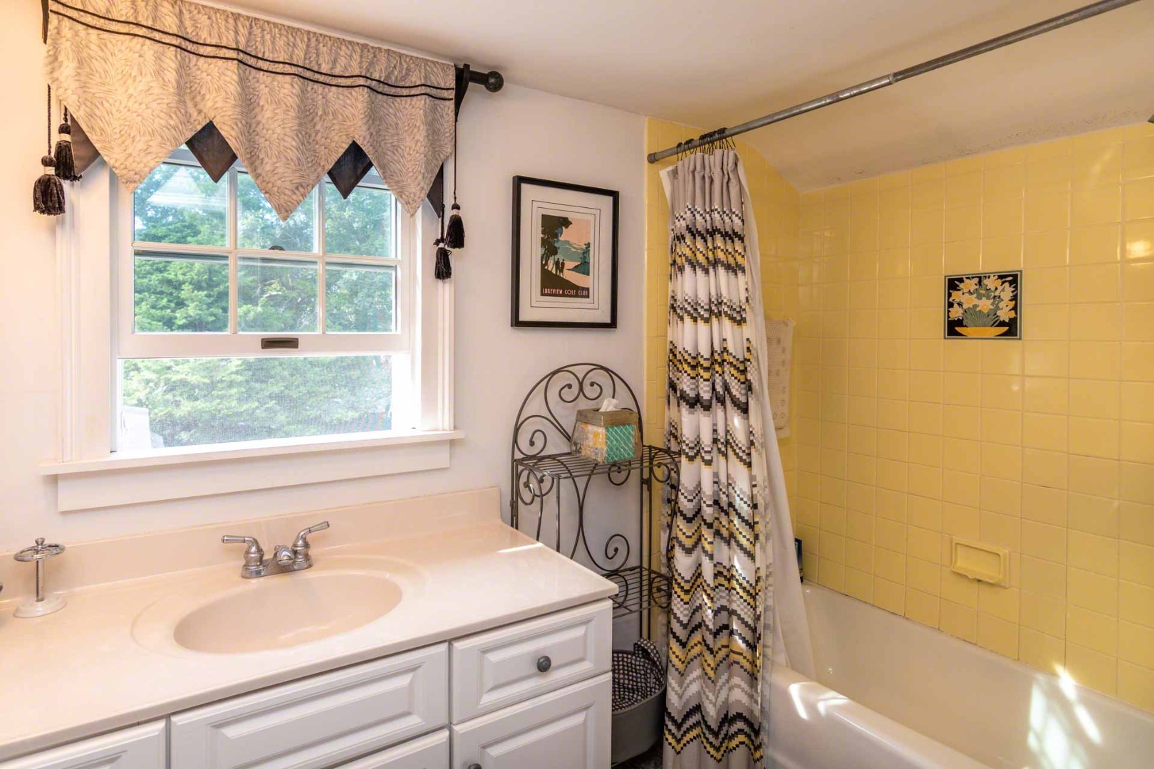 25 High Street Edgartown, MA 02539 - Photo 19 of 26 a bathroom with a sink a toilet and a shower curtain