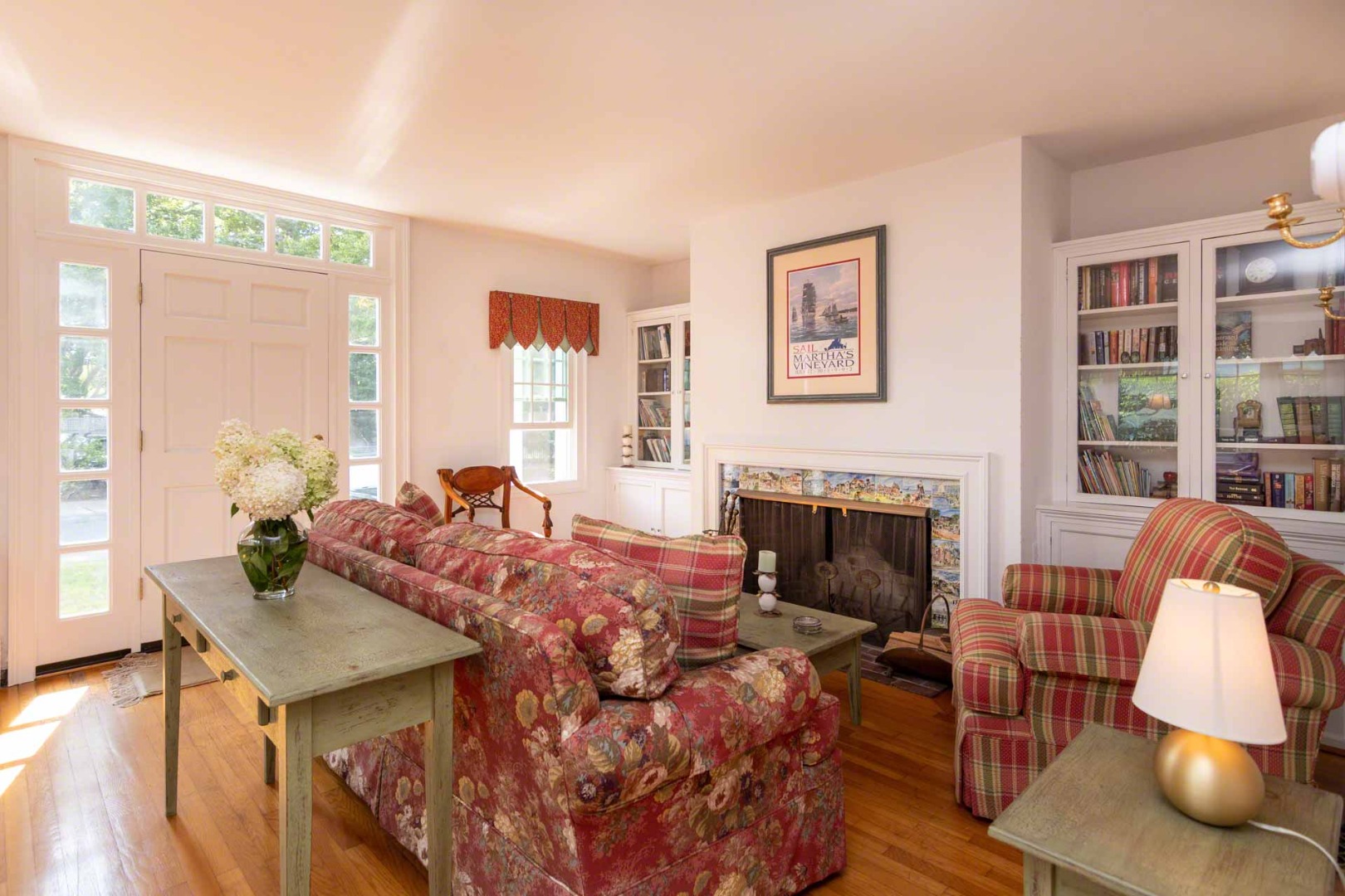 25 High Street Edgartown, MA 02539 - Photo 3 of 26 a living room with furniture a fireplace and a large window