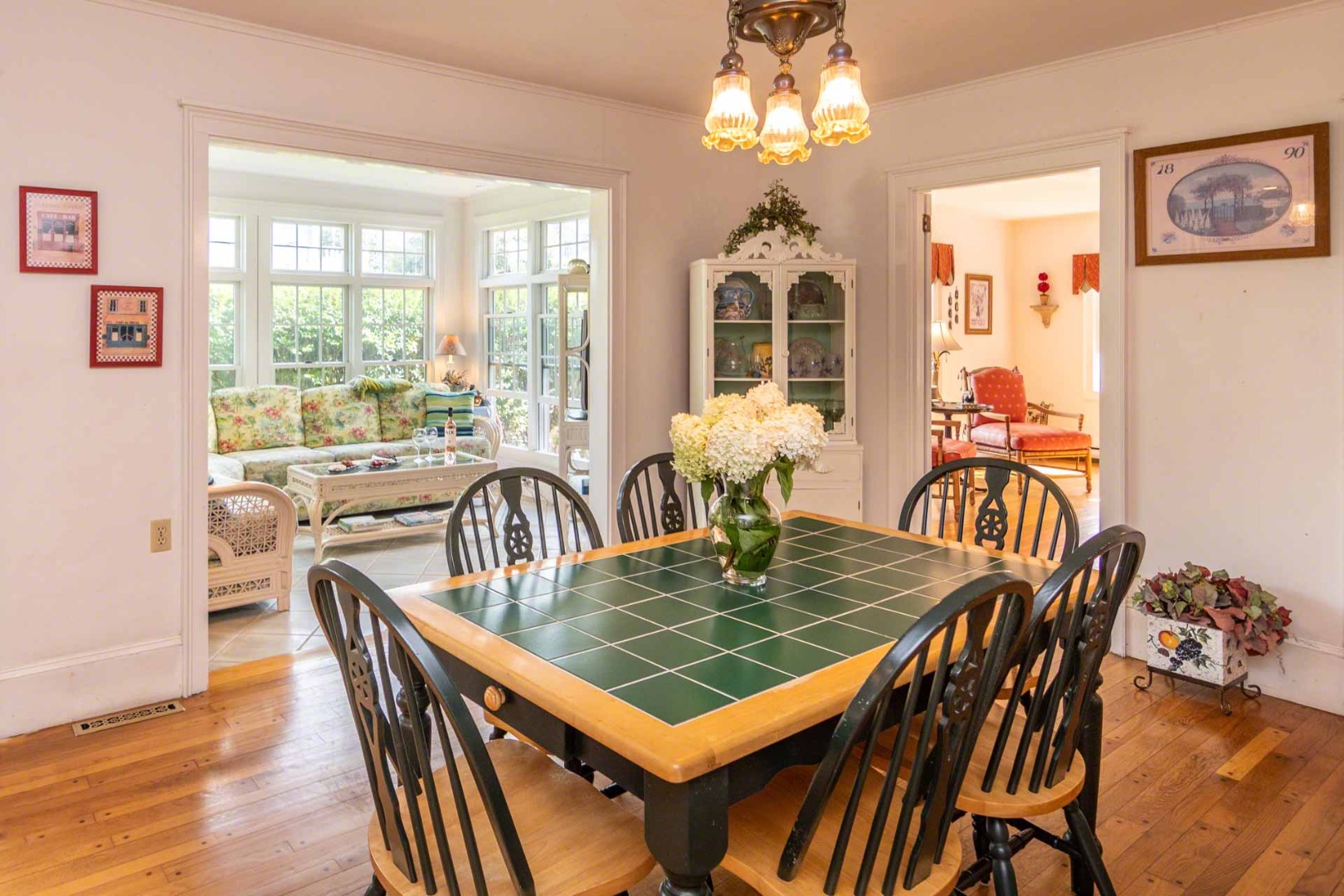 25 High Street Edgartown, MA 02539 - Photo 7 of 26 a view of a dining room with furniture a chandelier and wooden floor