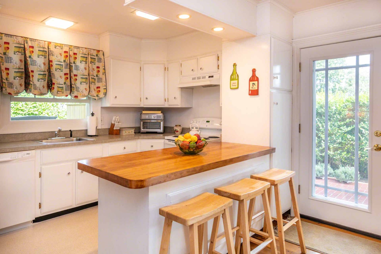 25 High Street Edgartown, MA 02539 - Photo 10 of 26 a kitchen with stainless steel appliances granite countertop a stove a sink and a refrigerator
