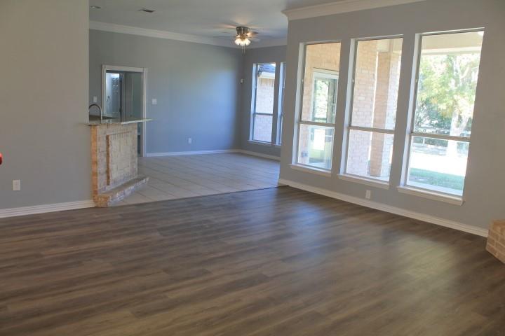 3051 Plainview Road Midlothian, TX 76065 - Photo 11 of 19 an empty room with wooden floor and windows