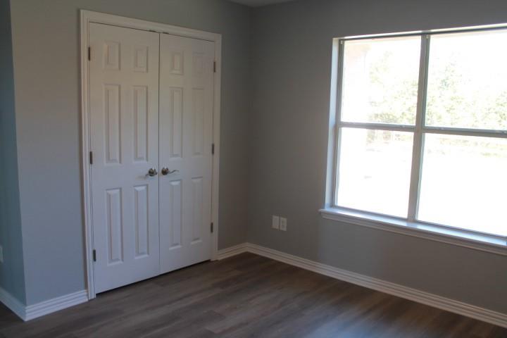 3051 Plainview Road Midlothian, TX 76065 - Photo 18 of 19 an empty room with wooden floor and windows