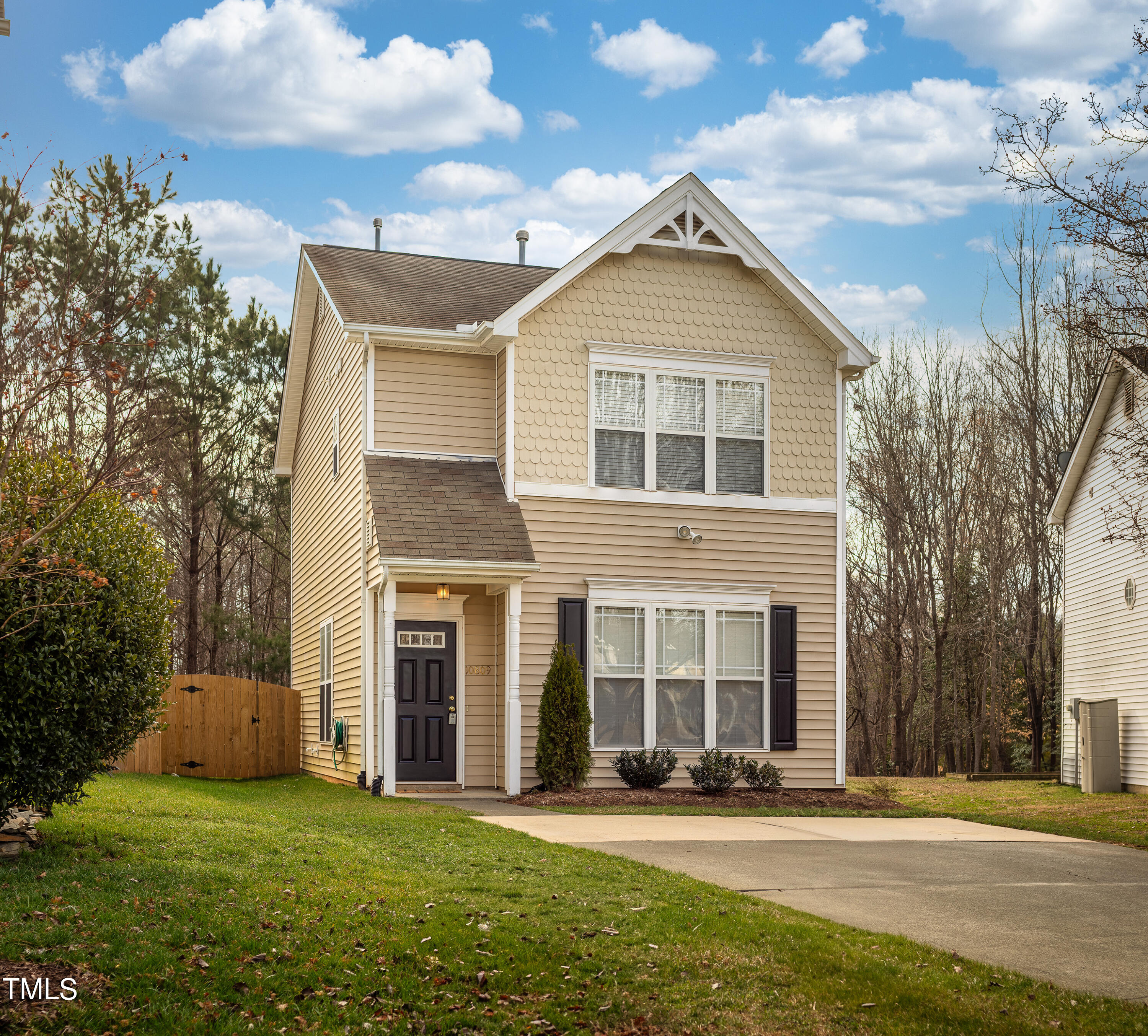 front view of a brick house with a yard