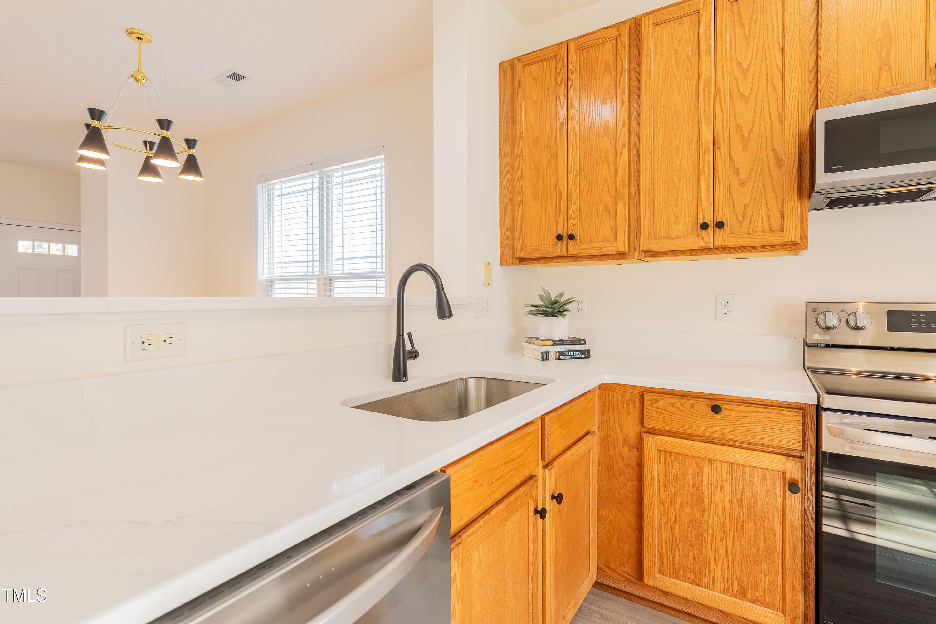 10809 Farmville Road Raleigh, NC 27614 - Photo 13 of 28 a kitchen with a sink cabinets and a window