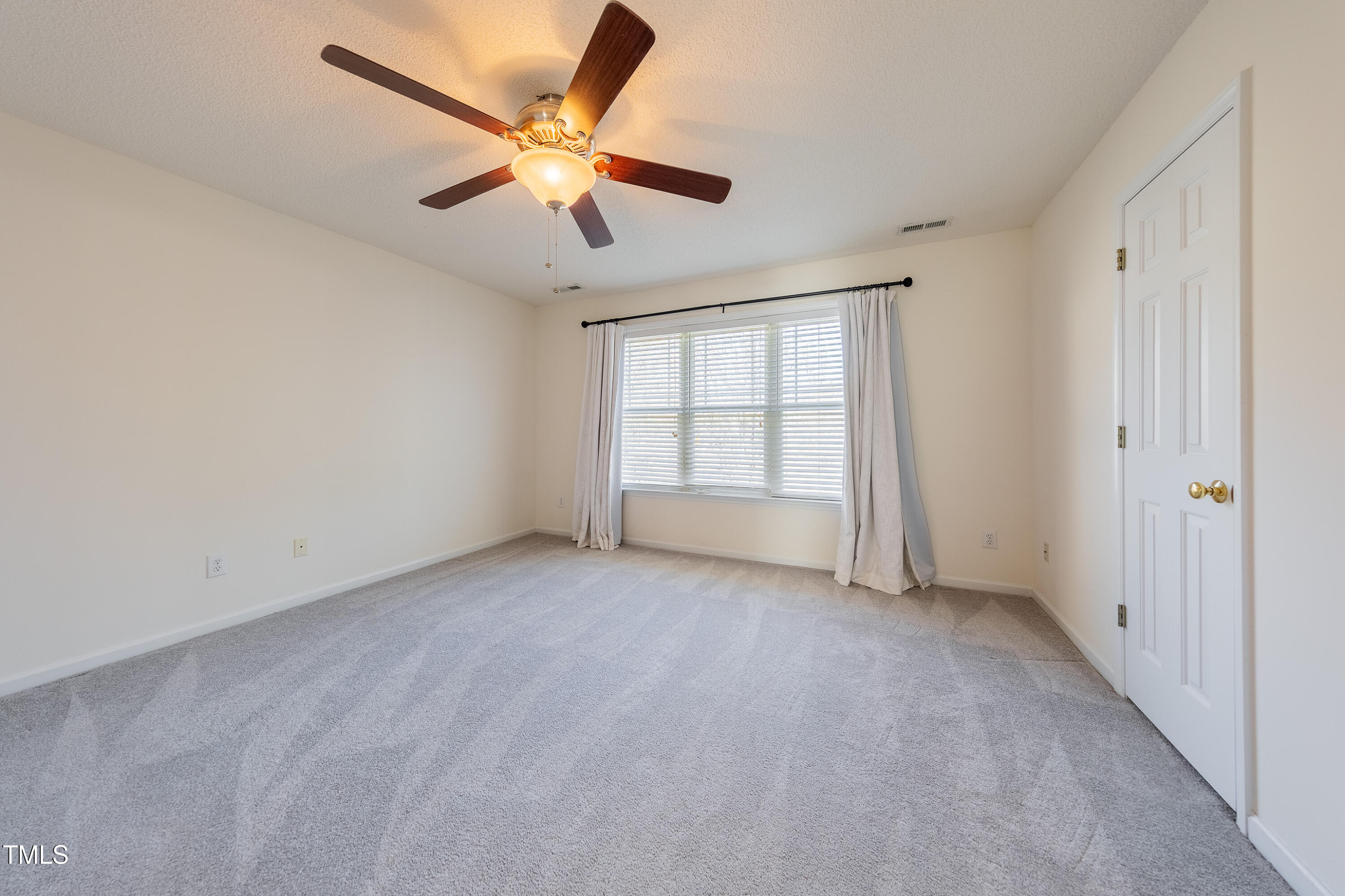 10809 Farmville Road Raleigh, NC 27614 - Photo 19 of 28 an empty room with fan and windows