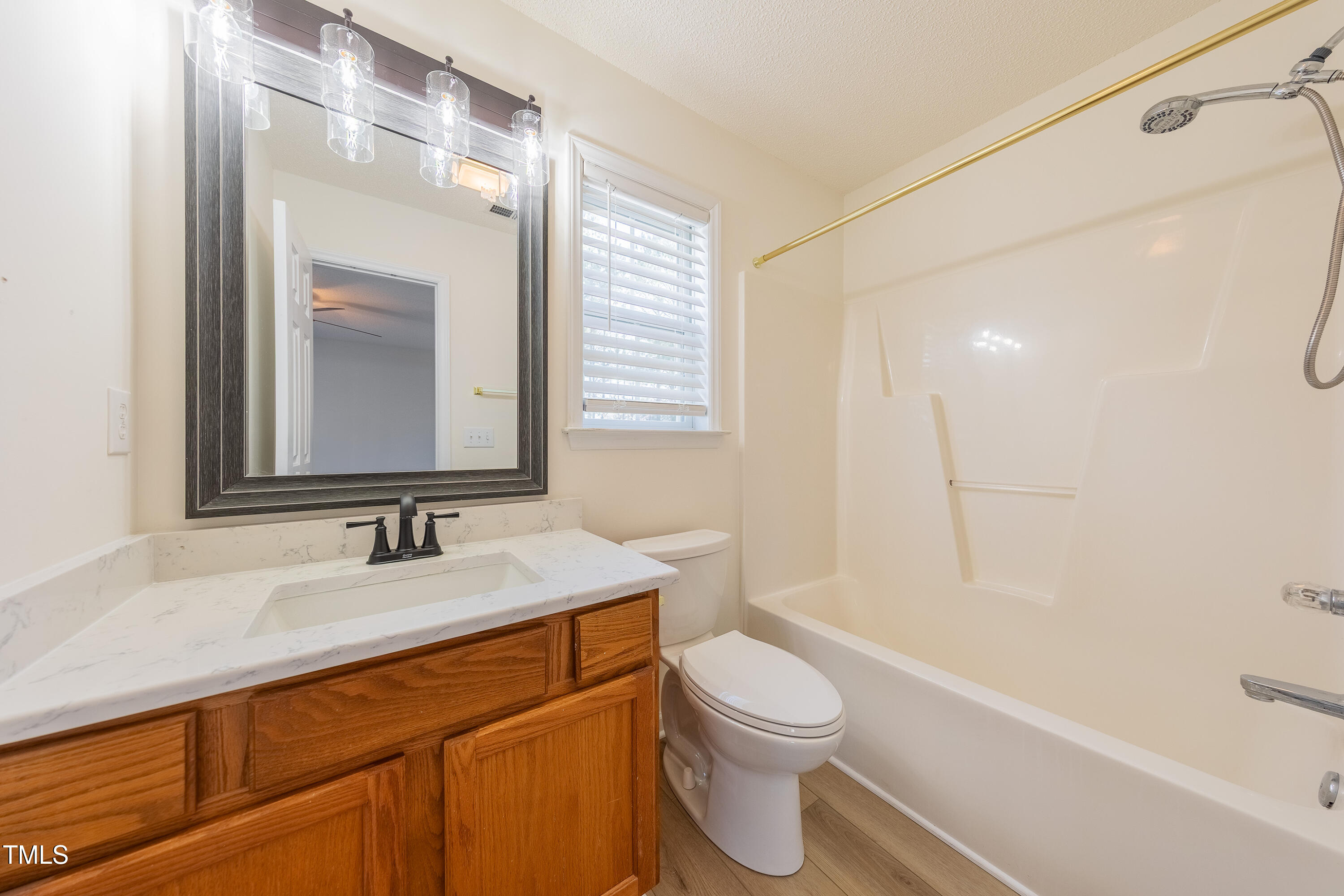 10809 Farmville Road Raleigh, NC 27614 - Photo 21 of 28 a bathroom with a sink a toilet and shower