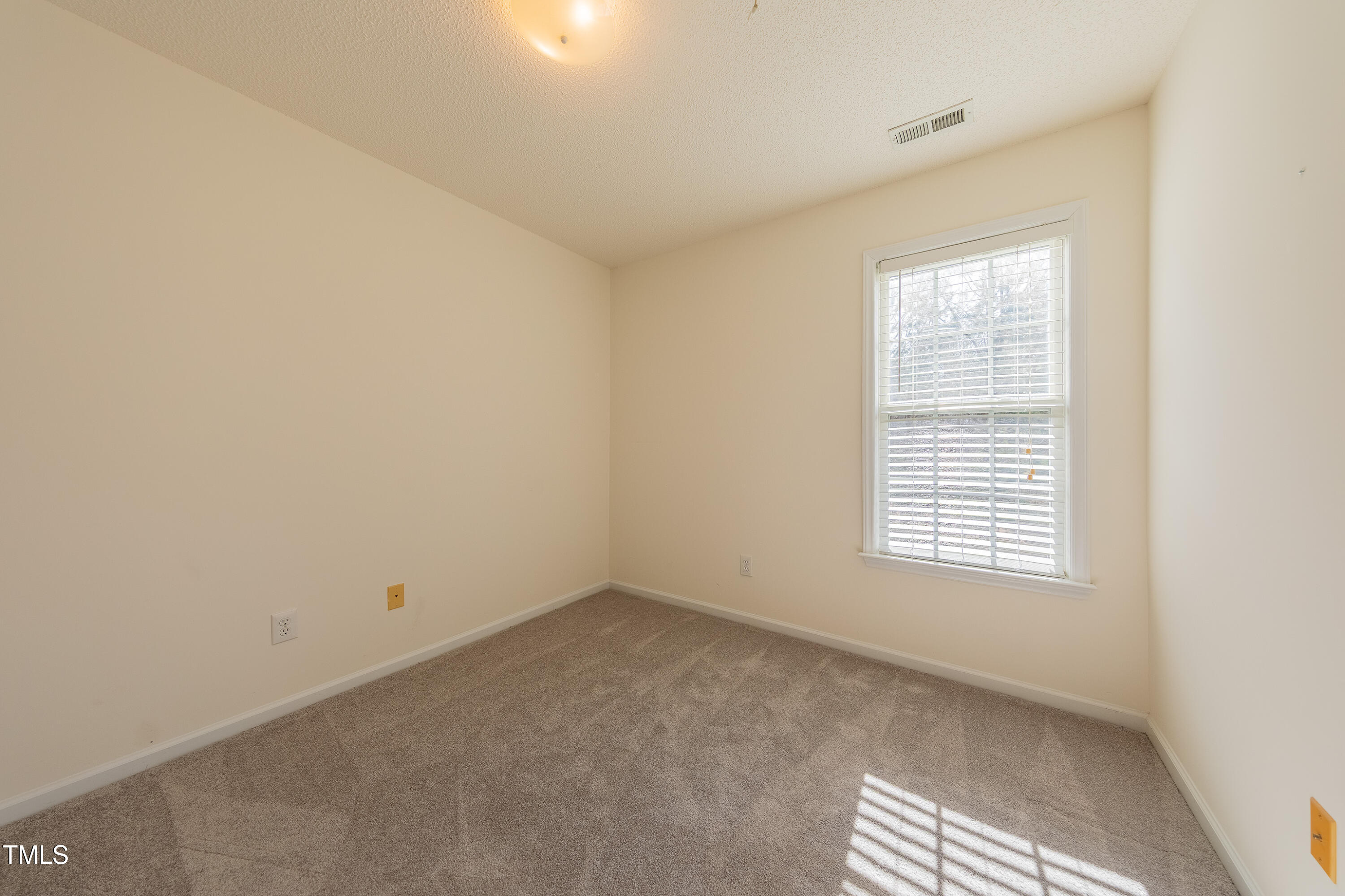 10809 Farmville Road Raleigh, NC 27614 - Photo 23 of 28 a view of an empty room with a window