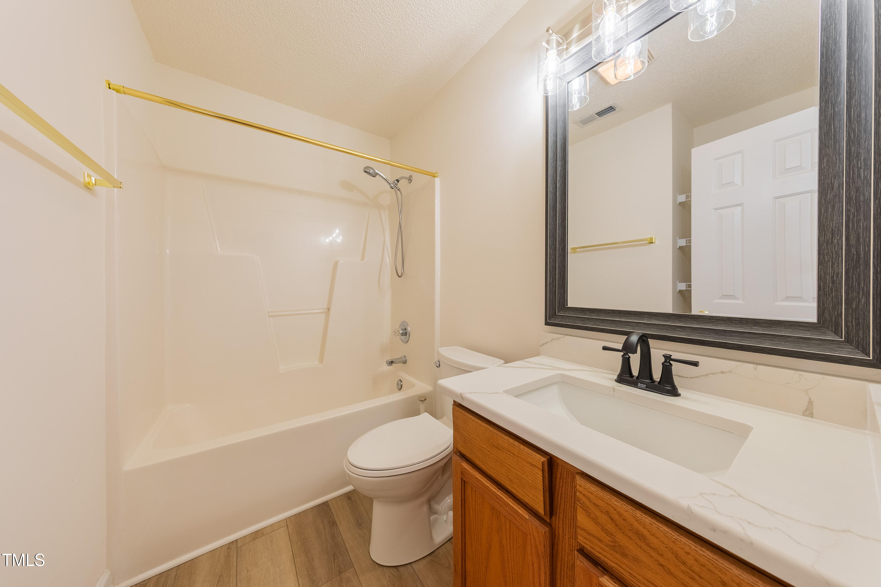 10809 Farmville Road Raleigh, NC 27614 - Photo 24 of 28 a bathroom with a sink a toilet and shower