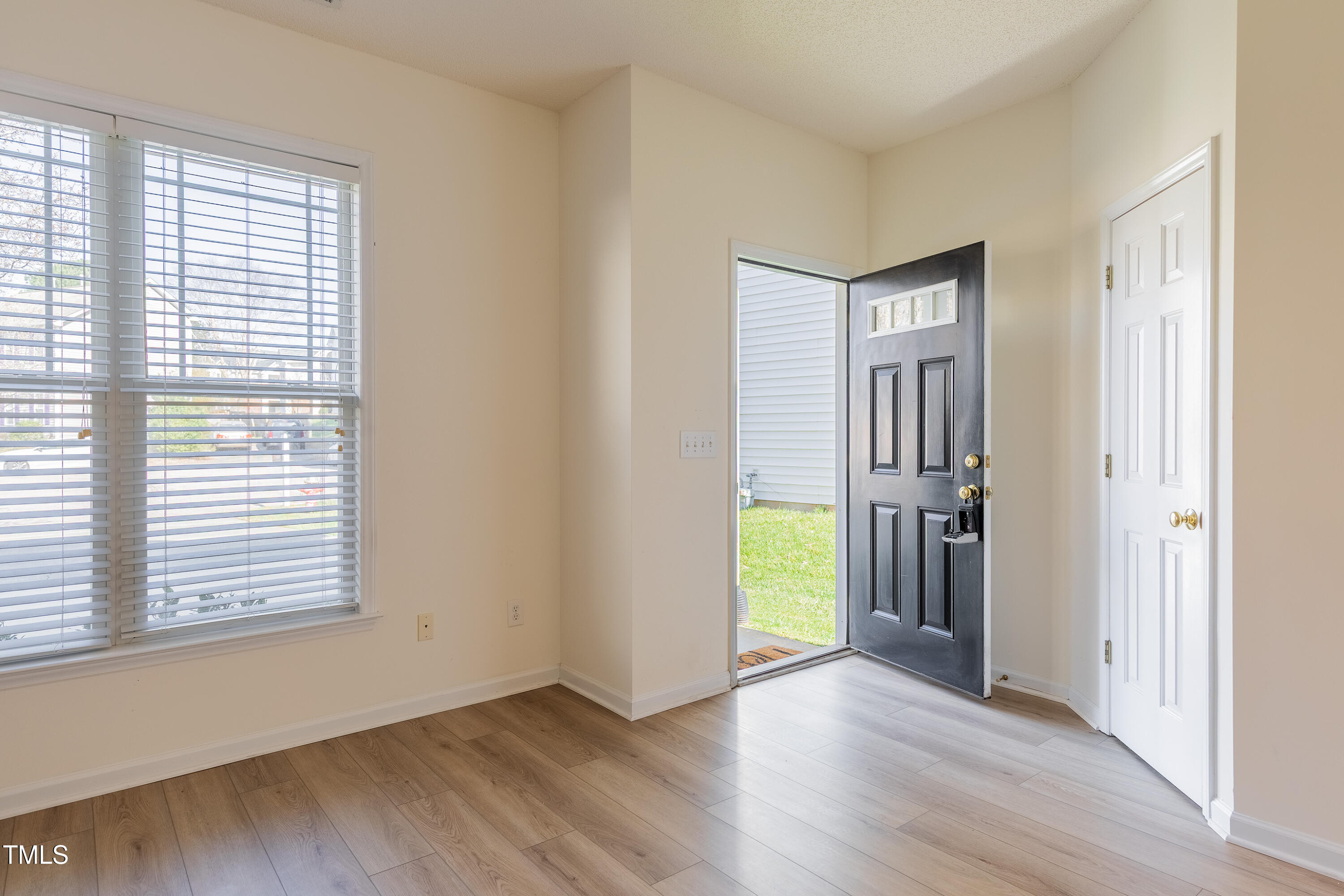 10809 Farmville Road Raleigh, NC 27614 - Photo 4 of 28 a view of empty room with wooden floor and fan