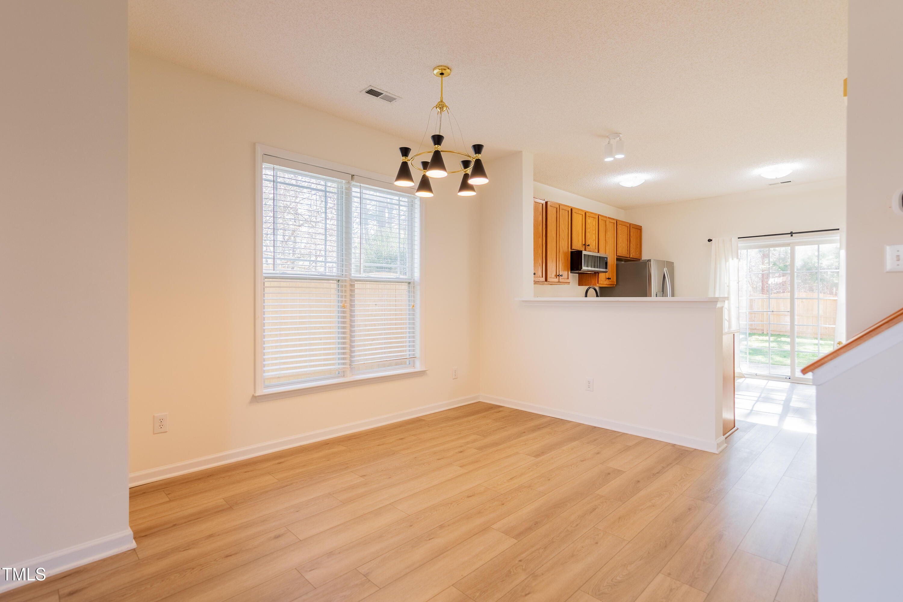 10809 Farmville Road Raleigh, NC 27614 - Photo 8 of 28 a view of a kitchen with wooden floor and natural light