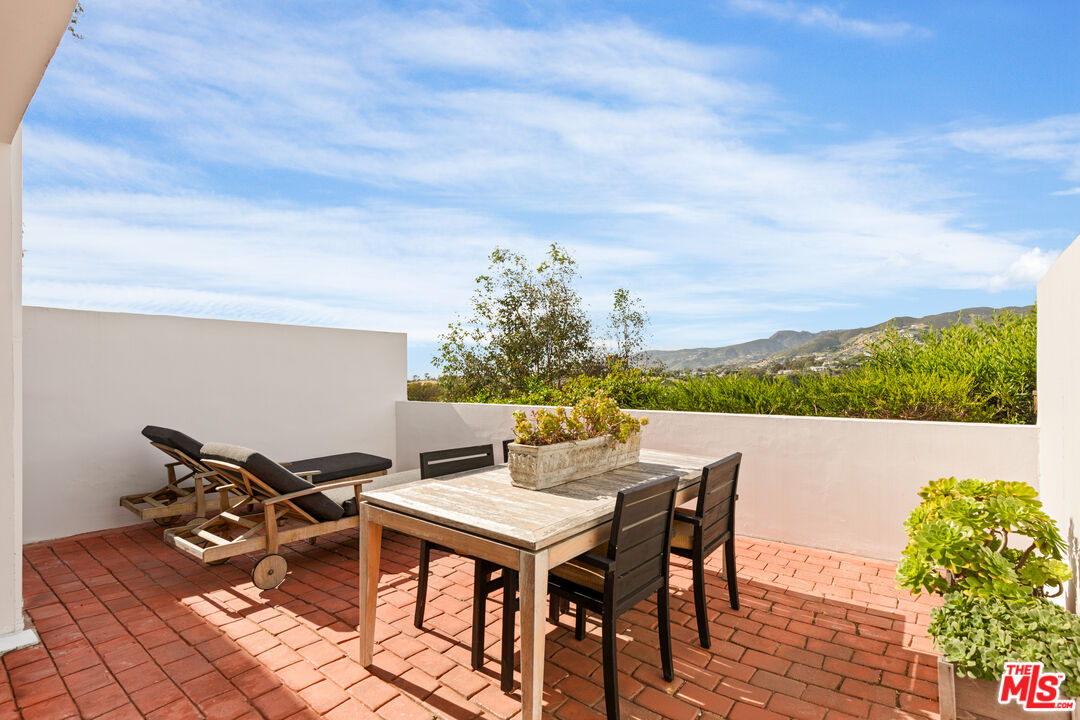 a view of a terrace with furniture and a table