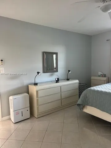 a living room with furniture and a lamp