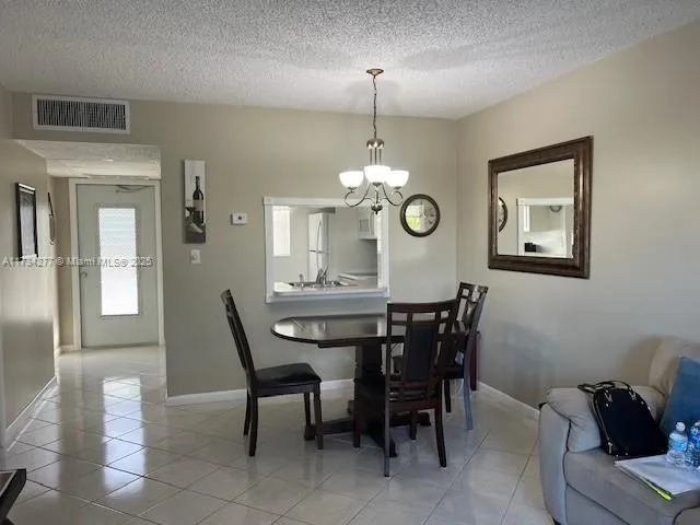 a view of a dining room with furniture and chandelier