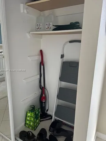 a view of kitchen with a sink and a refrigerator