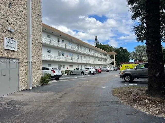 a view of an empty room with a floor to ceiling window and an outdoor kitchen
