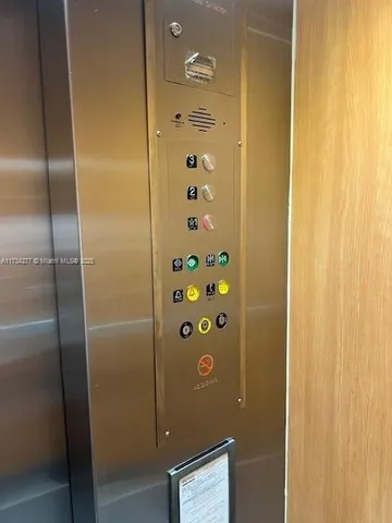 a view of a patio with a table and chairs under an umbrella