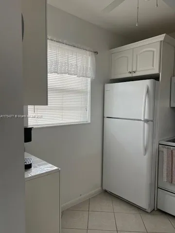 a utility room with cabinets washer and dryer