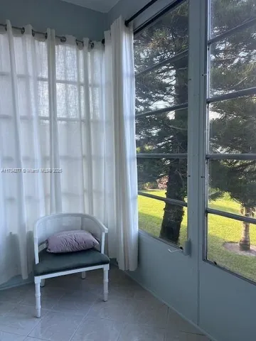 a bedroom with a bed and a view of the window